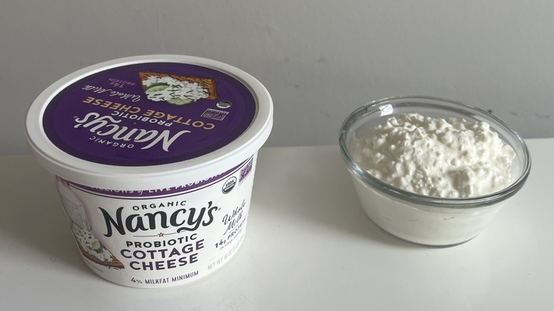 Tub of Nancy's cottage cheese next to a bowl