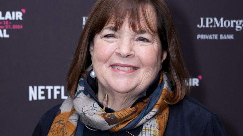 Ina Garten smiles in pearls and a scarf at a red carpet event