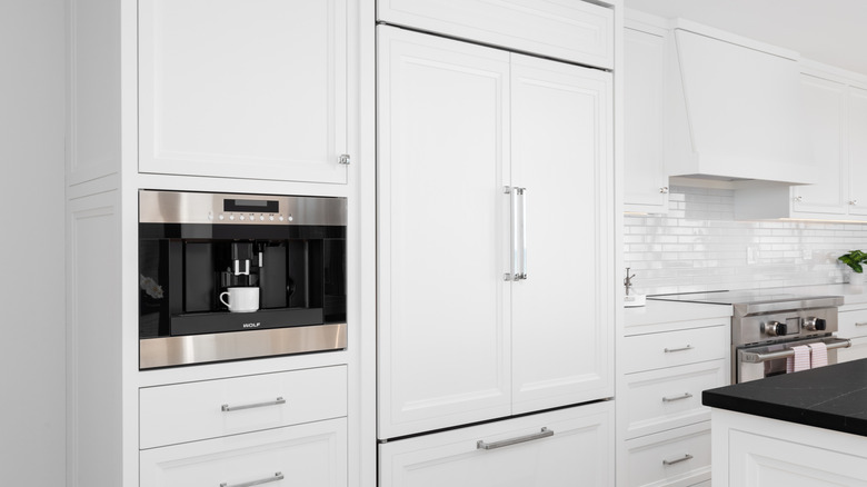 A built-in Sub-Zero refrigerator in a modern white kitchen