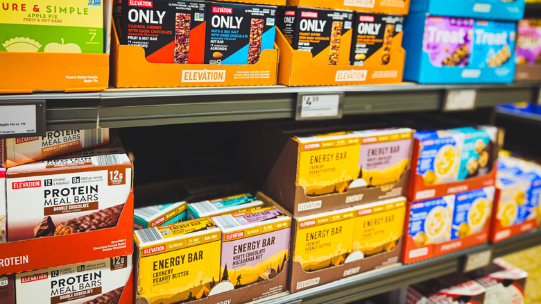Packaged snack bar displays on an Aldi shelf.