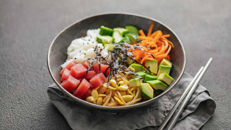 A simple ahi poke bowl staged with chopsticks
