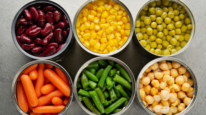 Overhead shot of various canned veggie inside their cans