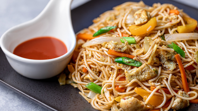 Stir-fried noodles with a side of ketchup