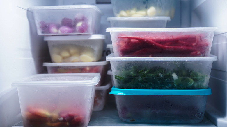 A freezer full of bulky containers with food