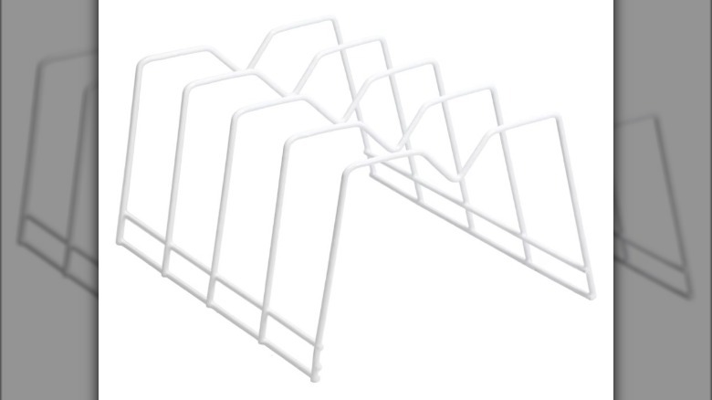 A woman reaching into her refrigerator