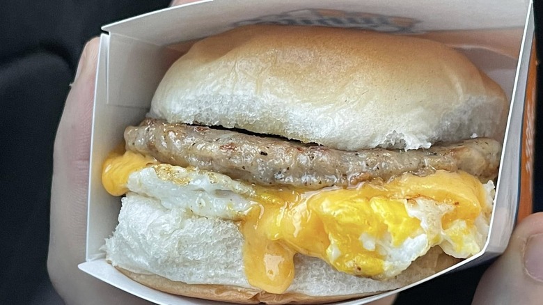 A White Castle Sausage, Egg, and Cheese breakfast slider in its box