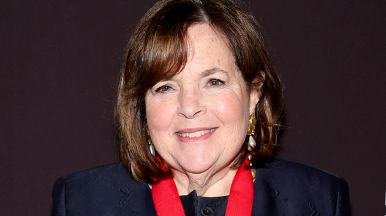 Ina Garten smiles in a black outfit at an event