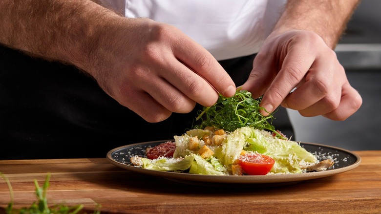 Chef placing final touches on a dish