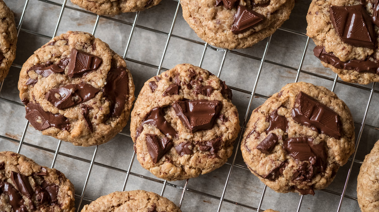 Rows of freshly made chocolate chip cookies on a cooling rack