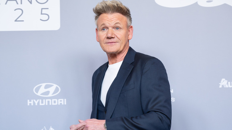Gordon Ramsay looking surprised at an event with a gray background