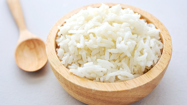 A wooden bowl of white rice.