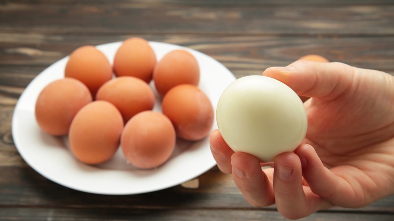 hand holding peeled boiled egg