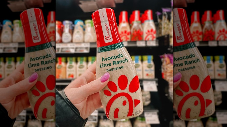 Handheld bottle of Chick-fil-A Avocado Lime Ranch Salad Dressing