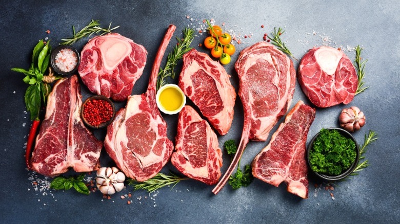 An assortment of thick raw steaks.