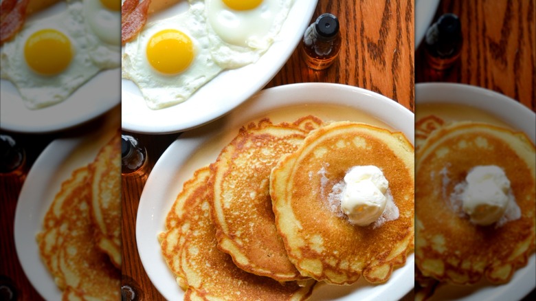 3 pancakes with butter, sunny side up eggs and bacon