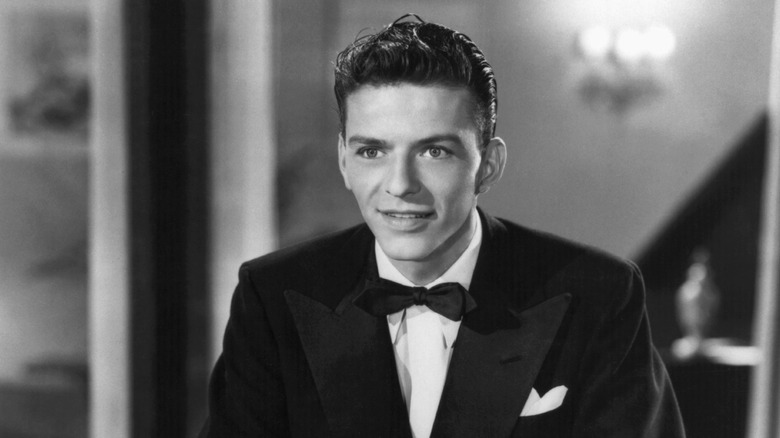 A black and white photo of a young Frank Sinatra in the movie "Higher and Higher"