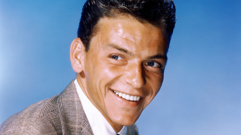 A color photo of a young Frank Sinatra in a suit