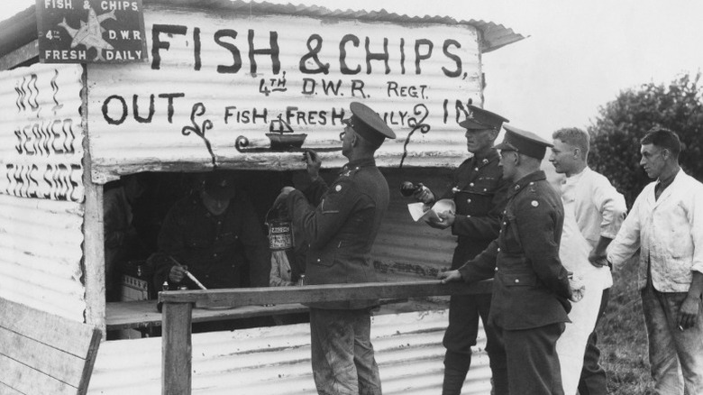 British army officers visiting a fish and chips stand.