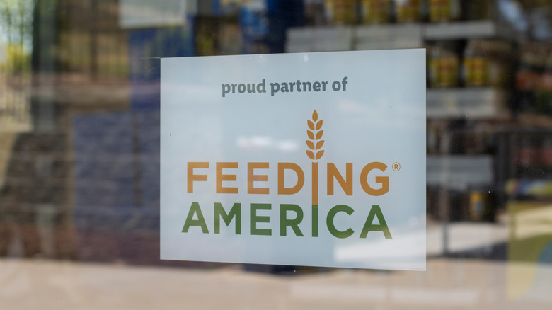 Proud partner of Feeding America sign in doorway of store