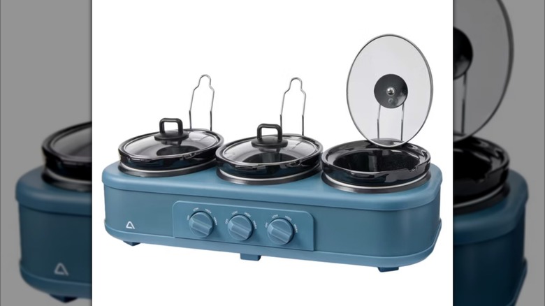 A blue Ambiano triple slow cooker from Aldi with lid rests
