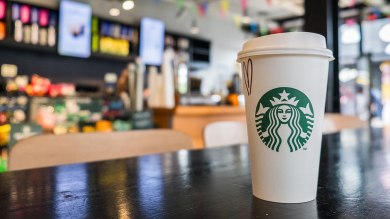 A cup of Starbucks coffee on a table in a Starbucks location