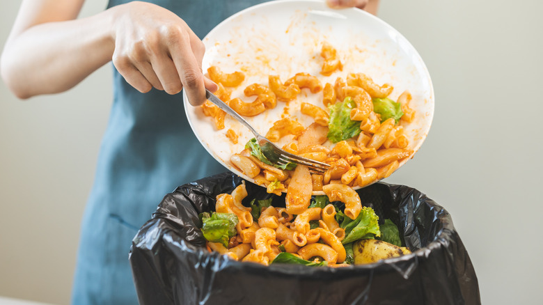 Food being scraped into the trash