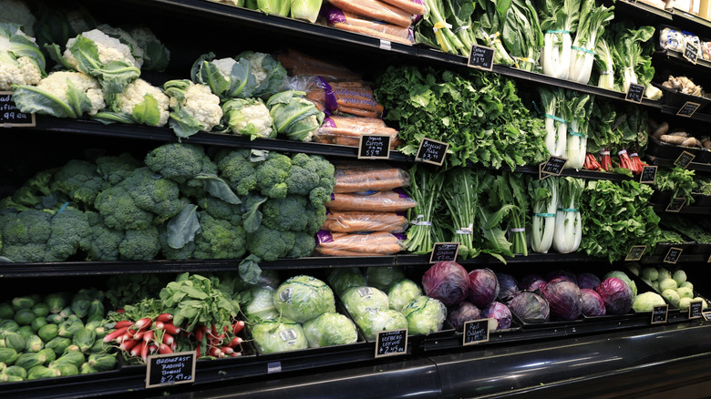 Assorted raw vegetables on refrigerated grocery store shelf