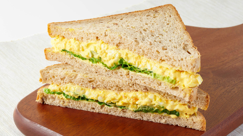 Egg salad sandwich on a wooden board