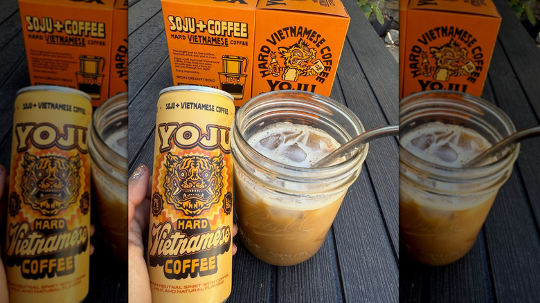 A hand holds a can of Yoju Vietnamese Coffee next to a mason jar glass and the drink's packaging