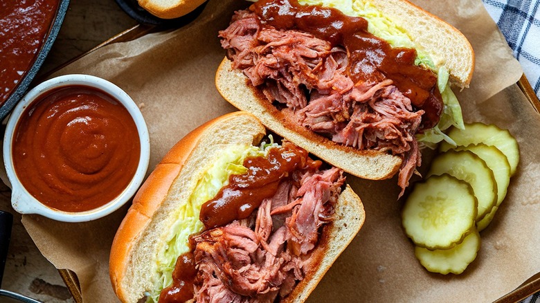 Pulled pork sandwiches with BBQ sauce and pickles overhead shot