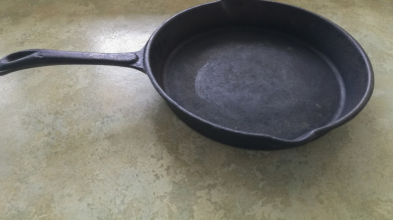 A vintage cast iron skillet on a countertop