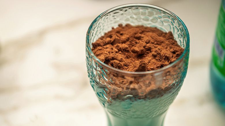 Powdered chocolate drink mix in glass