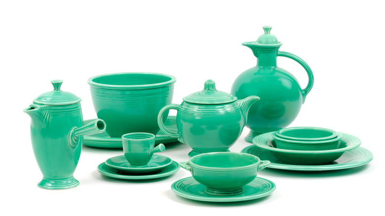 A set of green Fiest dishware including plates, bowls, tea set, and different sized jugs