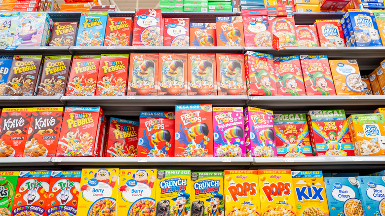 Colorful boxes of different cereal brands line grocery store shelves