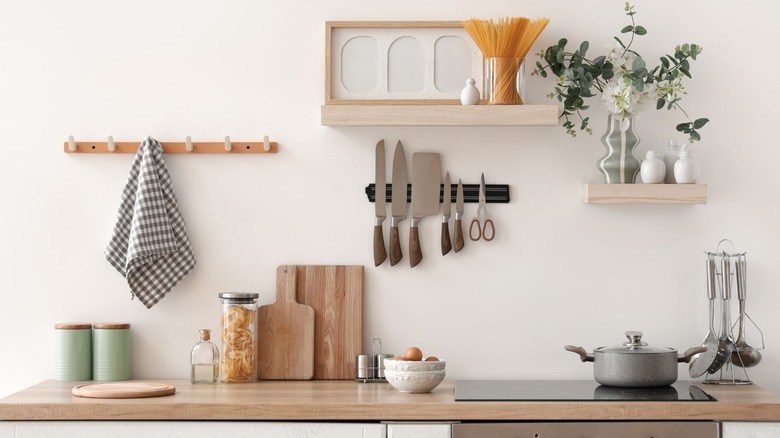The interior of a home kitchen featuring cutting boards, stovetop, and dried goods