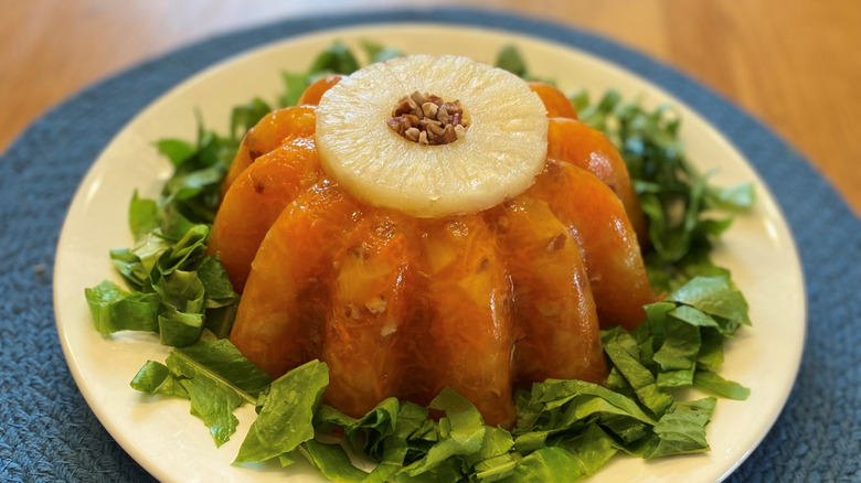 Jell-O mold salad with pineapple ring over shredded lettuce