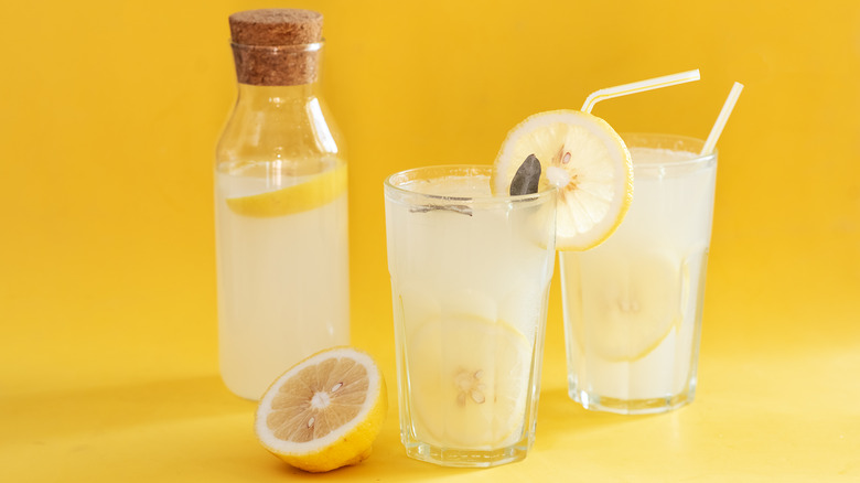 a jar and glasses filled with lemonade