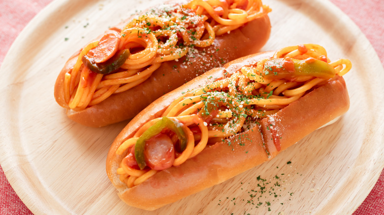 Two split buns stuffed with sausage and pepper spaghetti