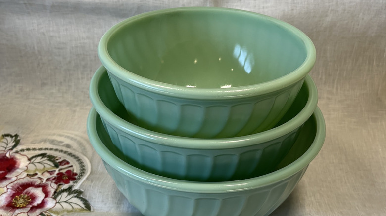 Three Jadeite green Fire-King mixing bowls with scalloped pattern.