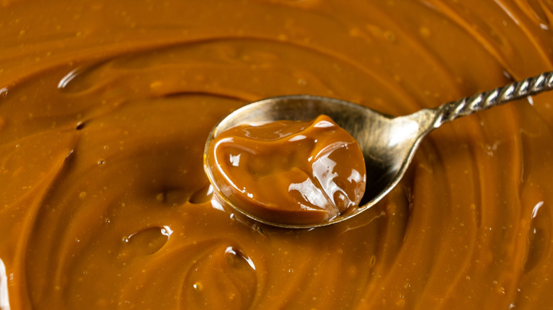 Closeup of dulce de leche on spoon.
