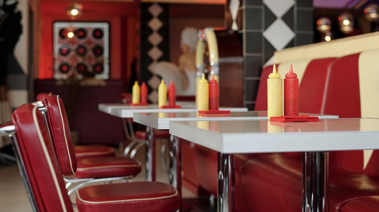 Interior of a 1950s-style diner with a red and white color scheme