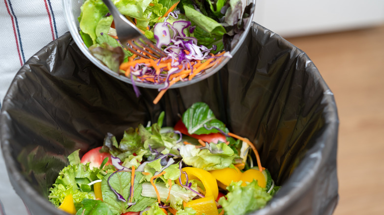 Throwing food waste into the trash