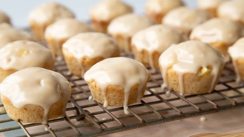 Baked mini apple fritters with maple glaze on wire cooling rack