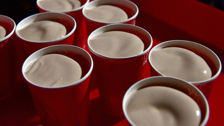 Several cups of Chocolate Frostys with no lids on them.