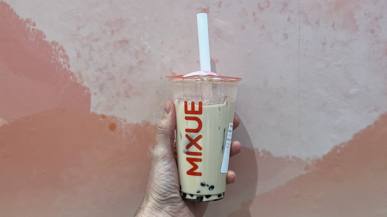 Hand holding a pearl milk tea