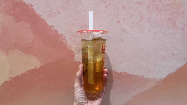 Hand holding an iced oolong tea