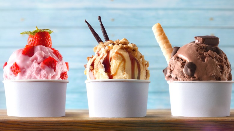 Three fancy-looking bowls of ice cream.