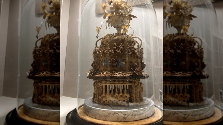 The oldest wedding cake on display in a bell jar in the Willis Museum.