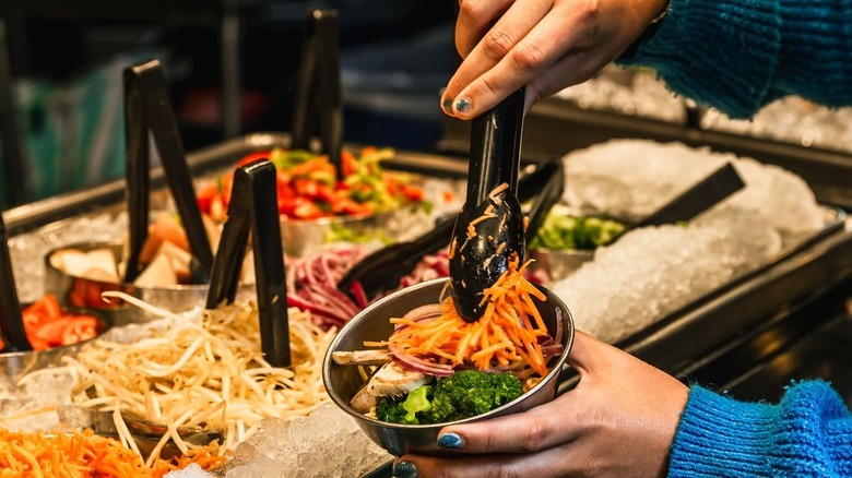 Customer filling a bowl at FiRE+ iCE
