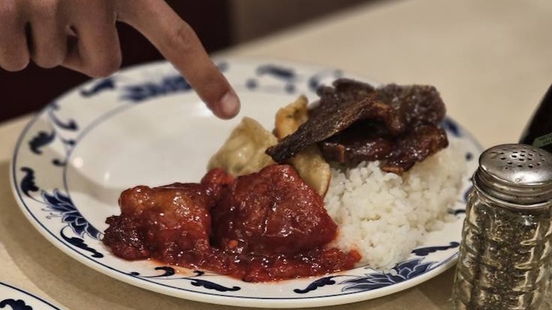 Finger pointing to plate of food at King Buffet in Reno